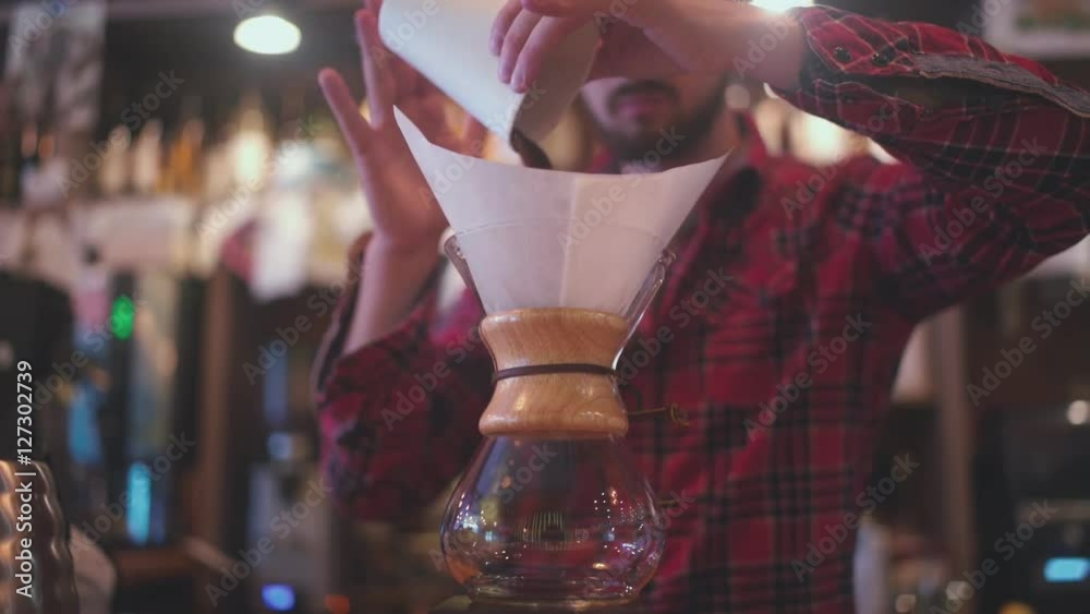 Coffee maker Chemeks: funnel glass. The bartender brews coffee using Coffee maker Chemeks. The bartender puts the filter in Coffee maker Chemeks and pours hot water.