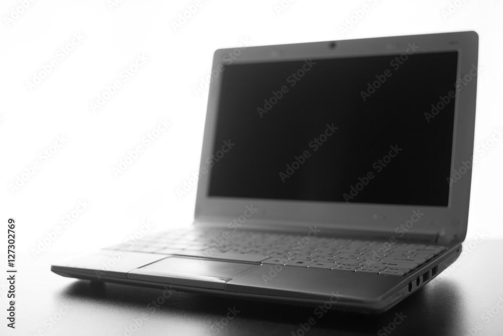 Compact white laptop silhouette on white background. Compact white laptop silhouette on white background.