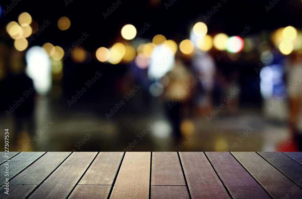 image of wooden table in front of abstract blurred background