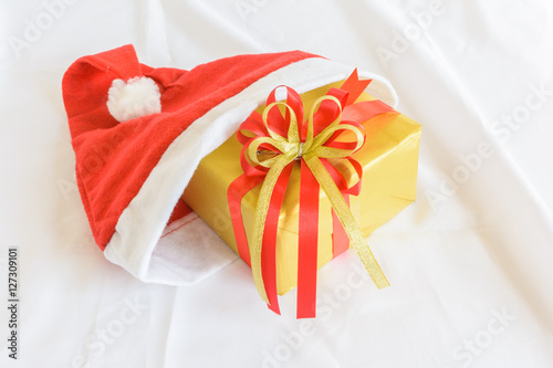 gift with color bow in a christmas hat on white cloth background