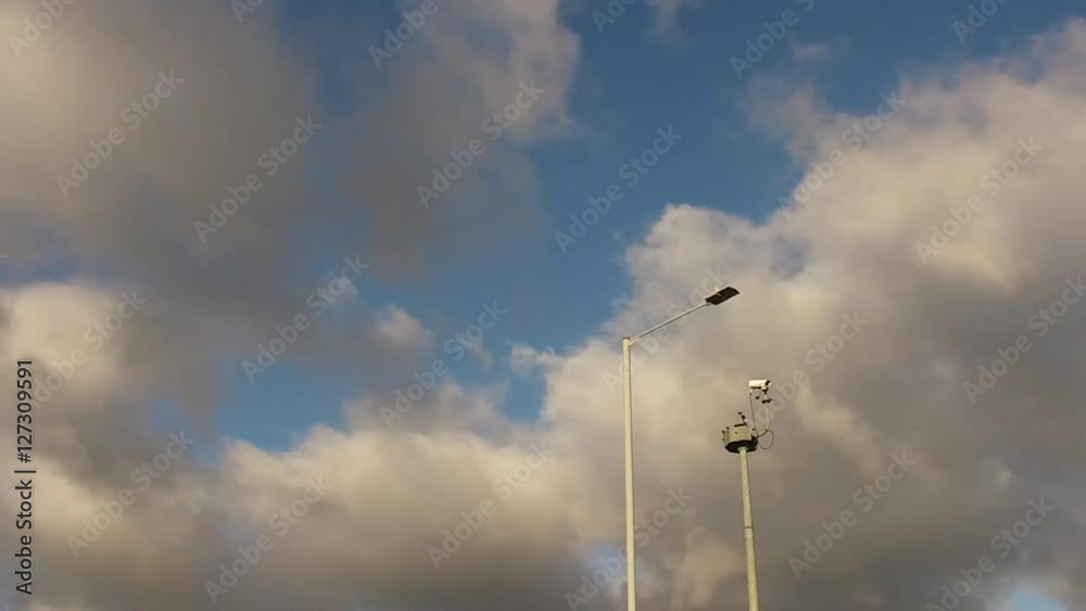 Slow motion panning shot of a security camera on a tall pole. Slow motion panning shot of a security camera on a tall pole.