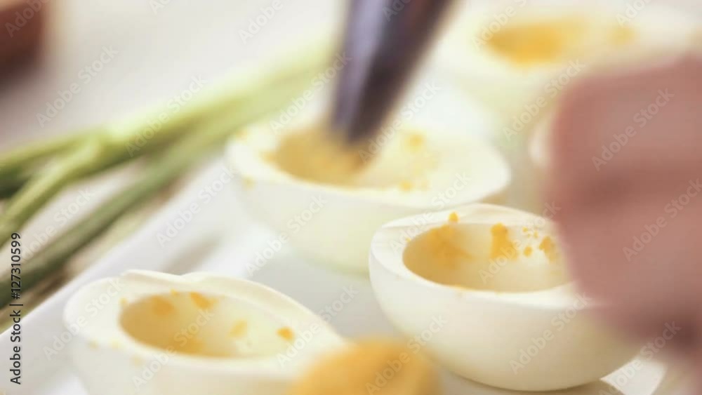 Time-lapse. Preparing deviled eggs with organic eggs for appetizer. Step by step recipe