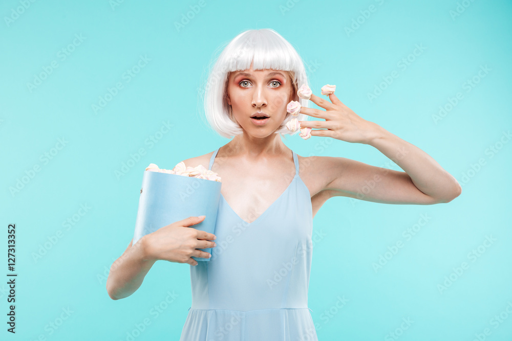 Pretty blonde young woman wih marshmallows on her fingers Pretty blonde young woman wih marshmallows on her fingers
