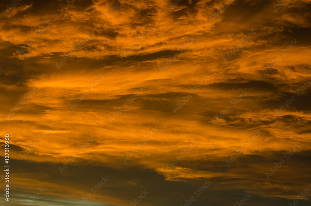 Flowing orange glowing clouds at sunset