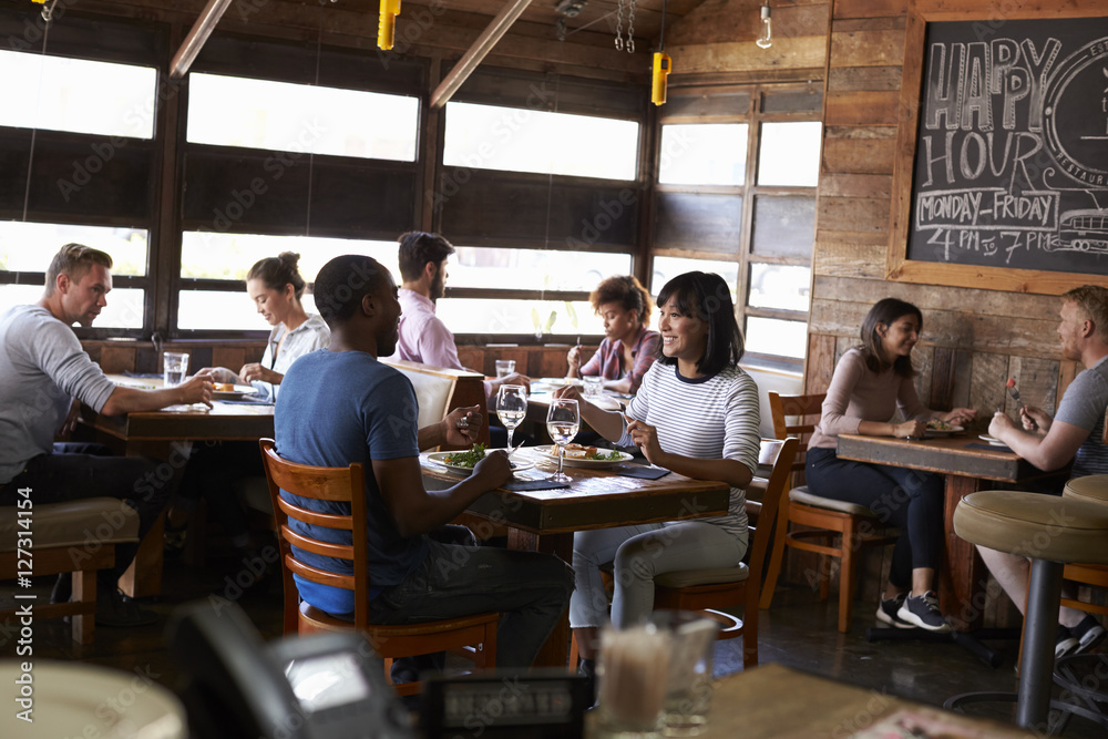 Couples enjoying lunch in a busy restaurant Couples enjoying lunch in a busy restaurant