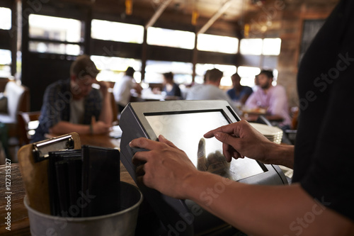 Preparing the bill at a restaurant using a touch screen till photo