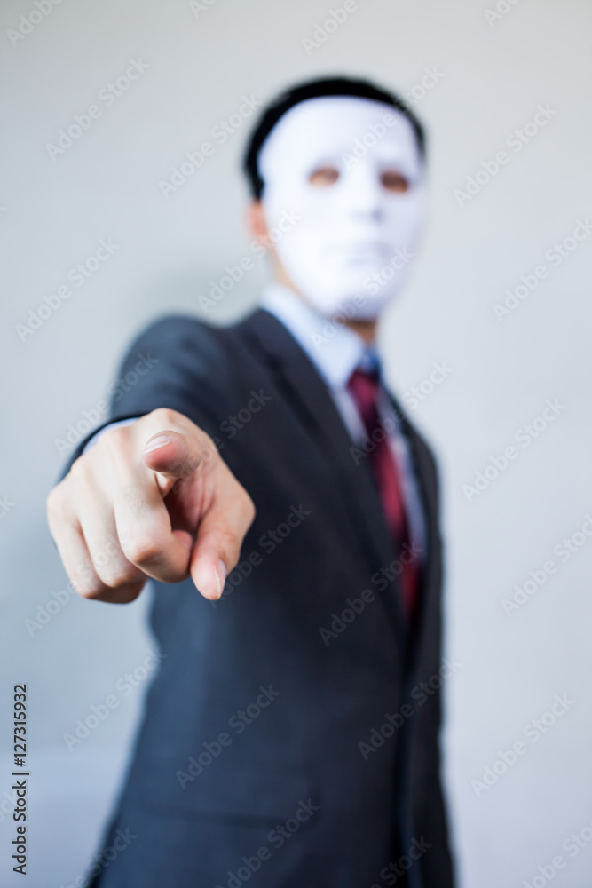 Man in white mask in business suit pointing fingers at