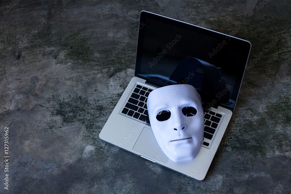 Anonymous mask to hide identity on computer laptop - criminal and cyber security threat concept Stock Photo | Adobe Stock