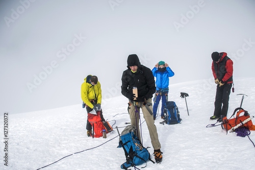 Group Hiking glacier Hvannadalshnukur summit in Iceland mountain landscape Vatnajokull park foggy