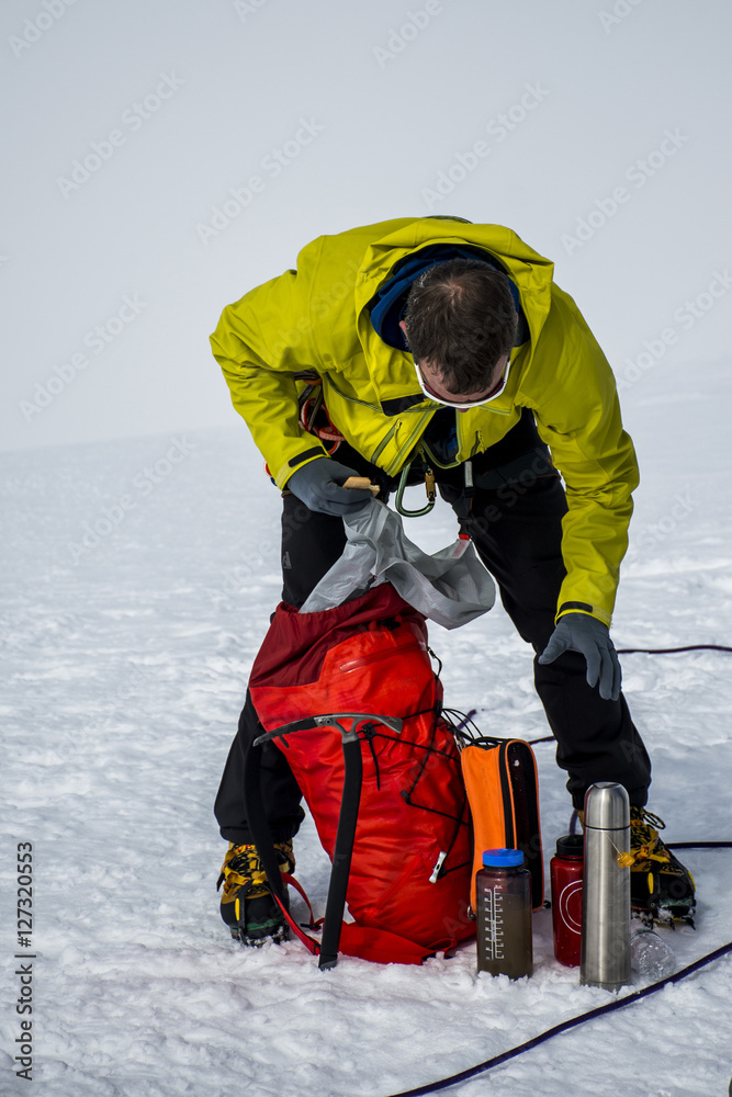 Men Hiking glacier Hvannadalshnukur summit in Iceland mountain landscape Vatnajokull park packing backpack