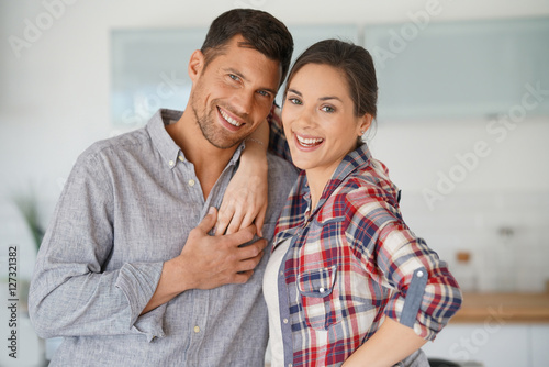 Happy couple standing in brand new home