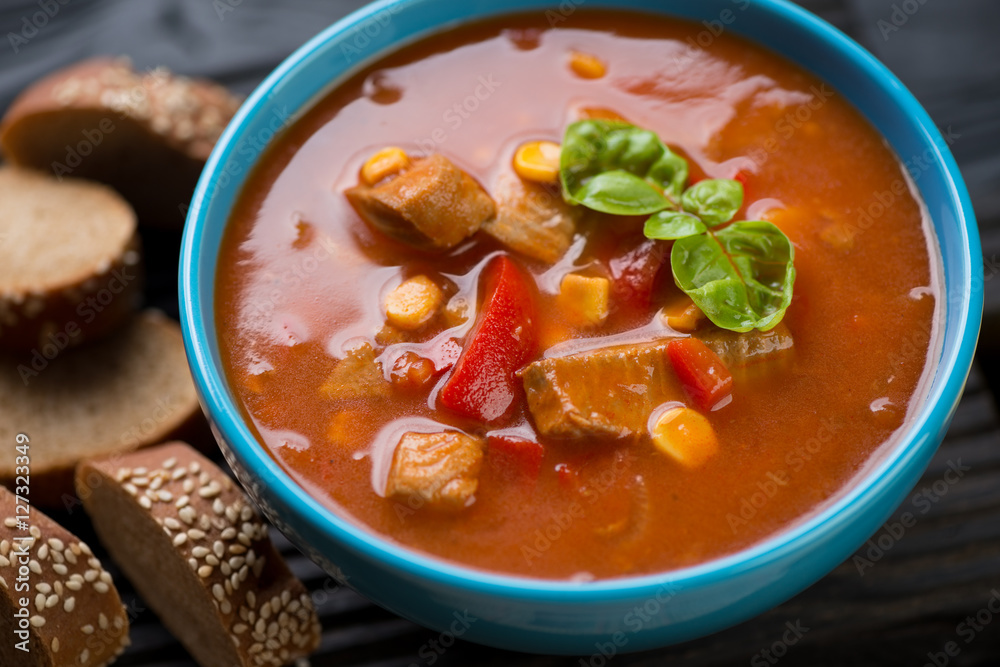 Close-up of tomato soup with tilapia fish and vegetables Close-up of tomato soup with tilapia fish and vegetables
