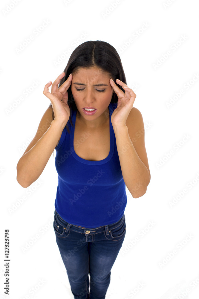 young attractive latin woman holding her head in stress suffering headache and migraine young attractive latin woman holding her head in stress suffering headache and migraine