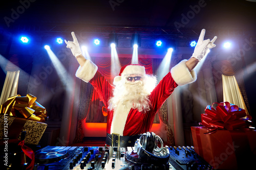 DJ Santa Claus mixing up some Christmas event.  Disco light arou