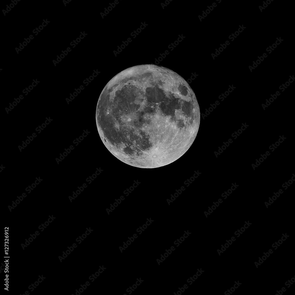 Full moon over dark black sky at night Full moon over dark black sky at night