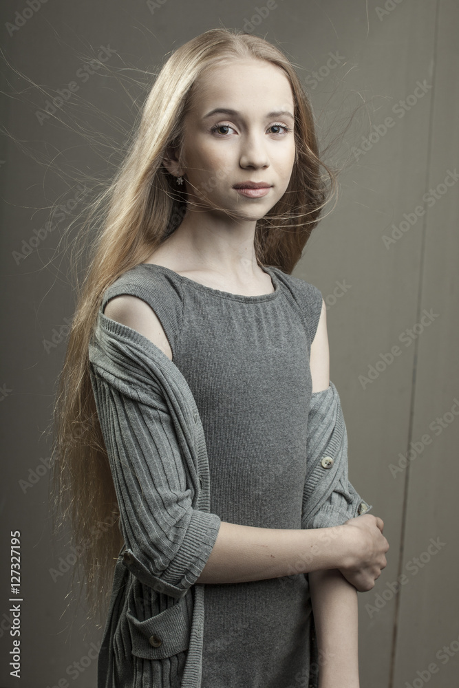 beautiful young girl in grey dress with blonde hair and green eyes Stock  Photo | Adobe Stock