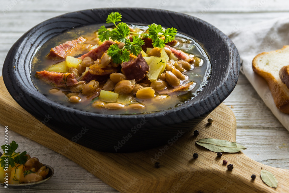 Bean, tomato, bacon and sausage stew with toasted bread Bean, tomato, bacon and sausage stew with toasted bread