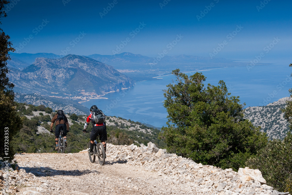Fototapeta premium Sardinia between mountains and sea - Riding mountain bike