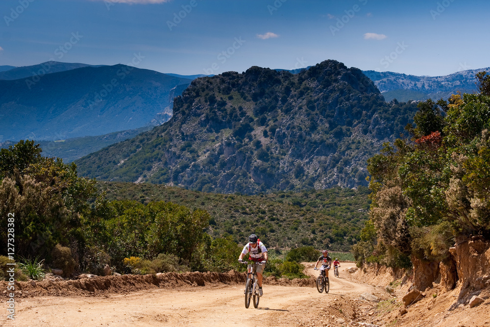 Fototapeta premium Sardinia between mountains and sea - Riding mountain bike