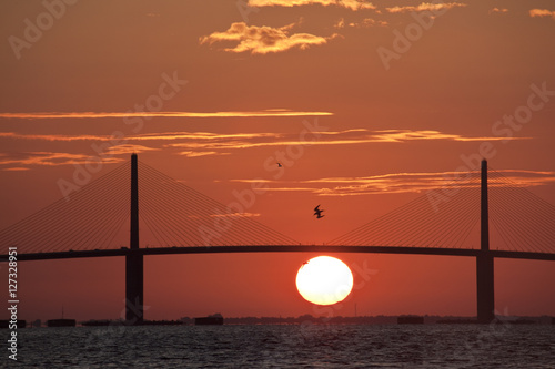 Sunrise behind the Sunshine Skyway bridge linking Tampa St. Petersburg, Fl to Sarasota across Tampa Bay.
