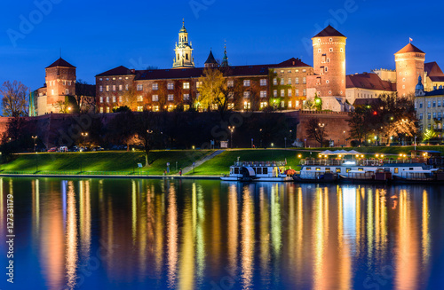 A night view of Wawel castle located on bank of Vistula river in Krakow city, Poland.