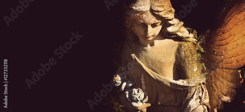 Photography golden angel in the sunlight (antique statue)