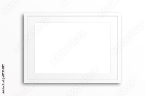 Blank white frame on plain wall. Interior decor mock up