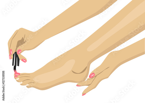 woman applying nail polish on her toes
