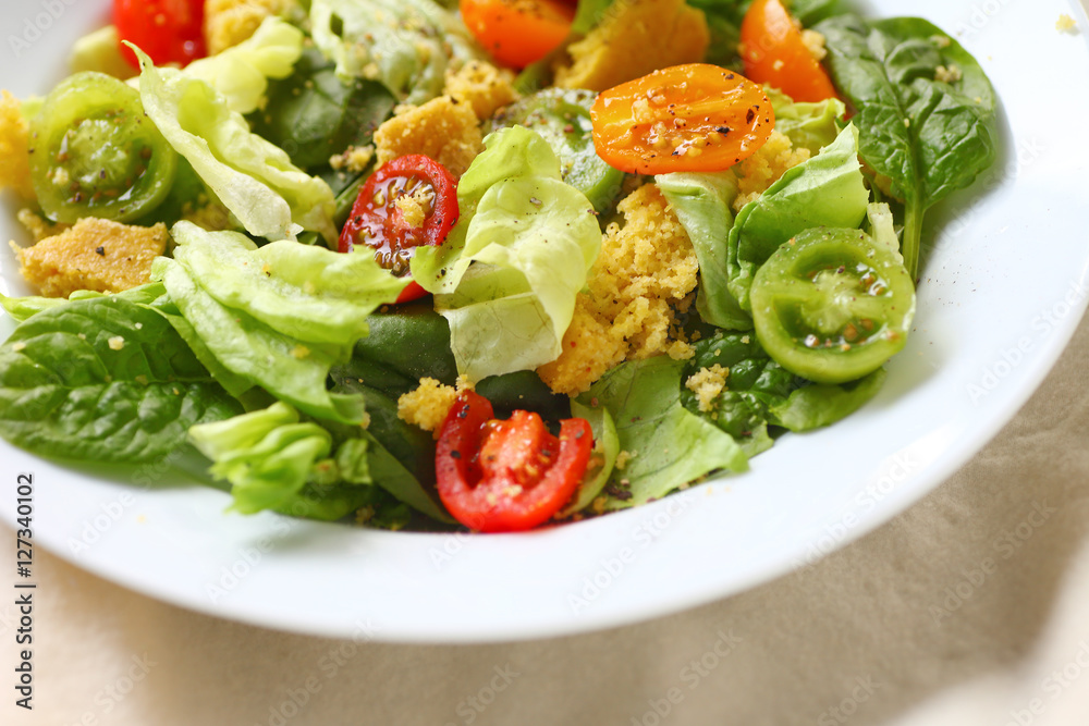 Closeup of butter lettuce and spinach salad with crumbled cornbread Closeup of butter lettuce and spinach salad with crumbled cornbread