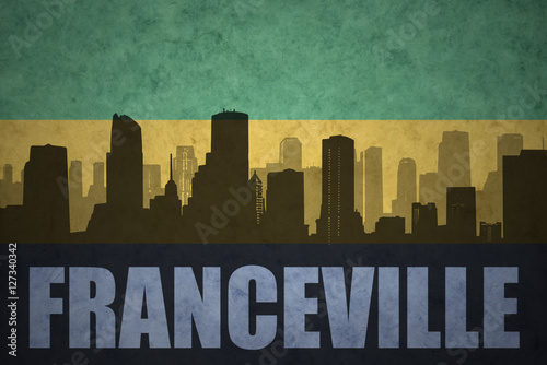 abstract silhouette of the city with text Franceville at the vintage gabonese flag