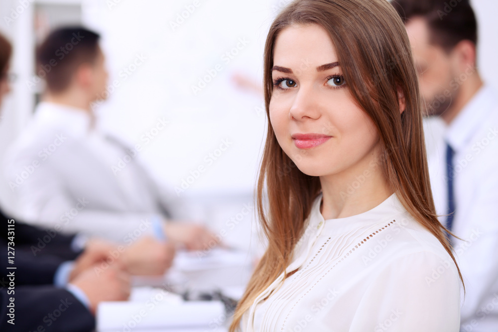 Portrait of a young business woman at meeting. Portrait of a young business woman at meeting.