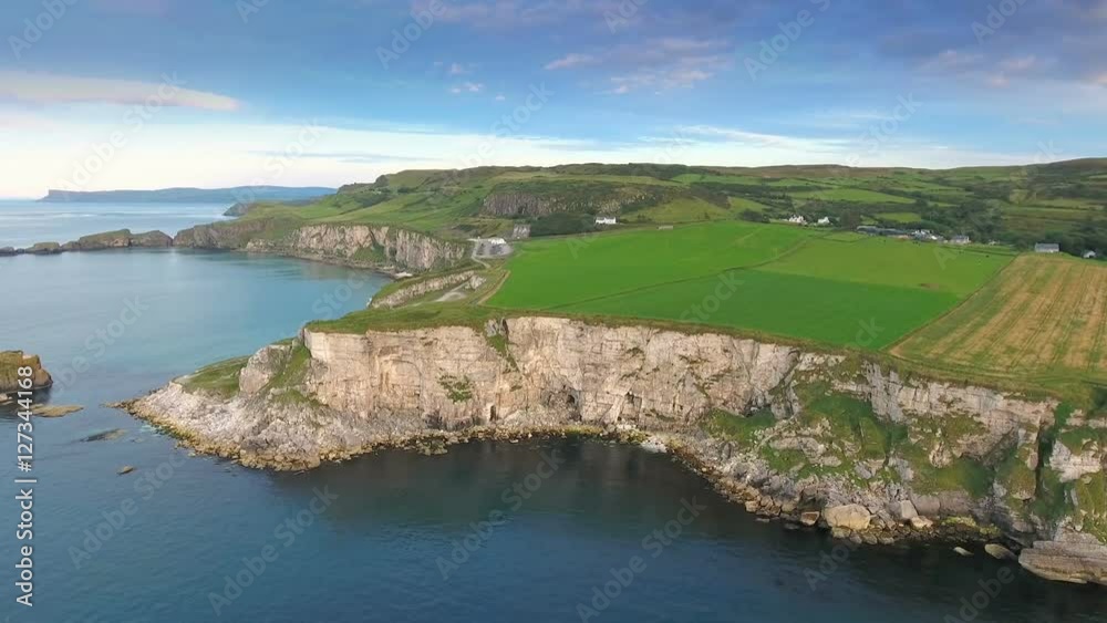 Aerial view of the cliff in Carrick-a-Rede Ireland where rock formatiuons are found on the ocean fronting the mainland in Ireland Aerial view of the cliff in Carrick-a-Rede Ireland where rock formatiuons are found on the ocean fronting the mainland in Ireland