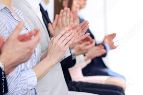 Close up of business people hands clapping at conference