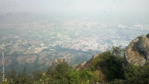 Thousands Dragonflies (Odonatoptera) hover on top of sacred mountain Tiruvannamalai (Tamilnad, India), where during holidays and to monastery rises thousands of Indian pilgrims
 photo