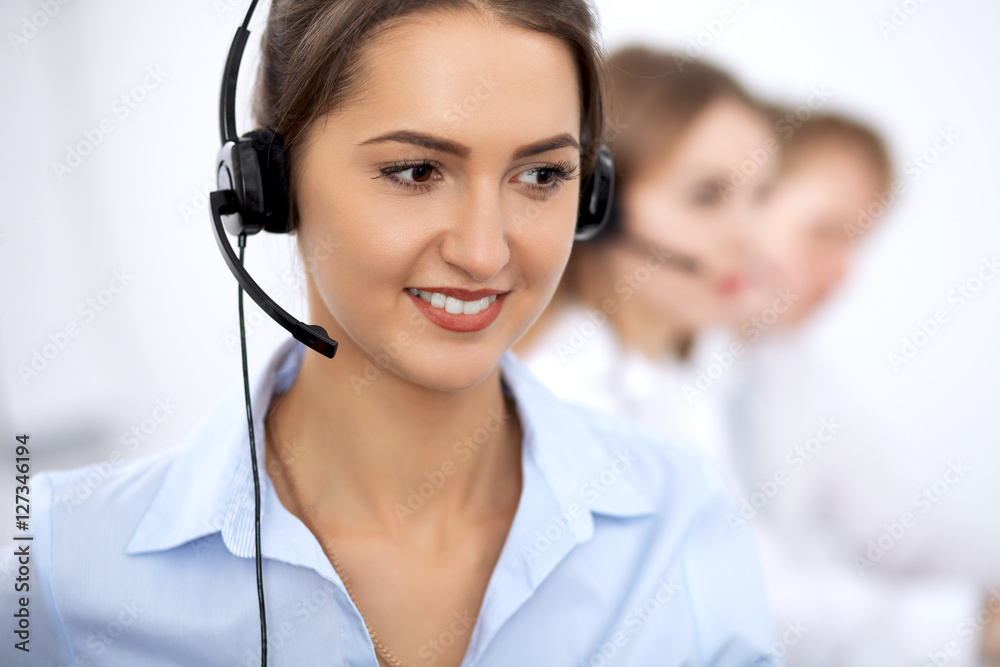Call center. Focus on beautiful woman in headset Call center. Focus on beautiful woman in headset