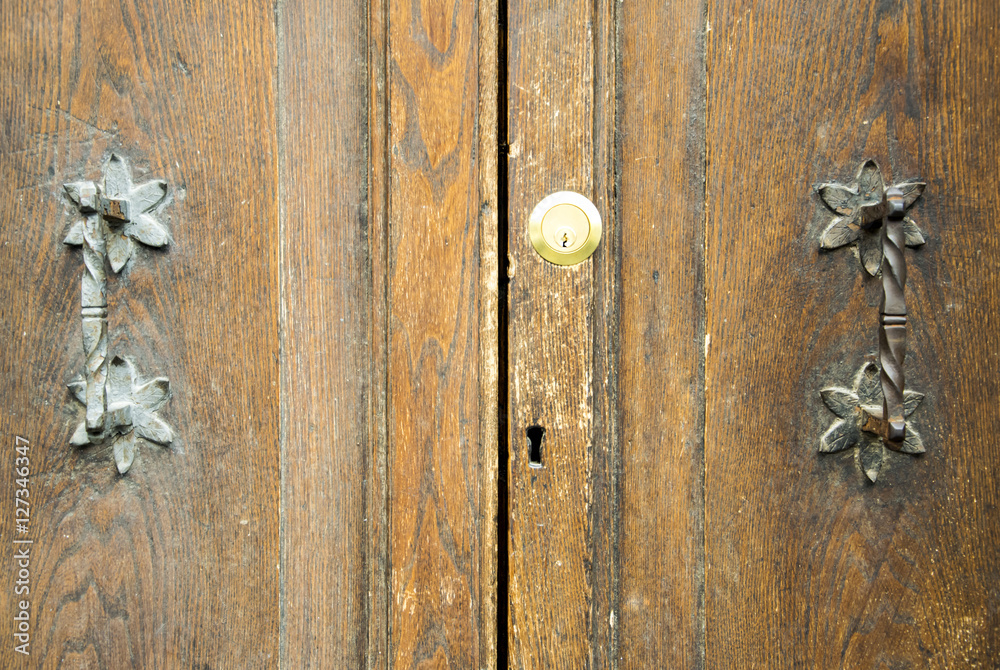 Details of an ancient Italian door in Florence, Italy. Details of an ancient Italian door in Florence, Italy.