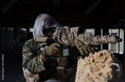 Sniper aim target with scope kneeling position  © John Vlahidis
