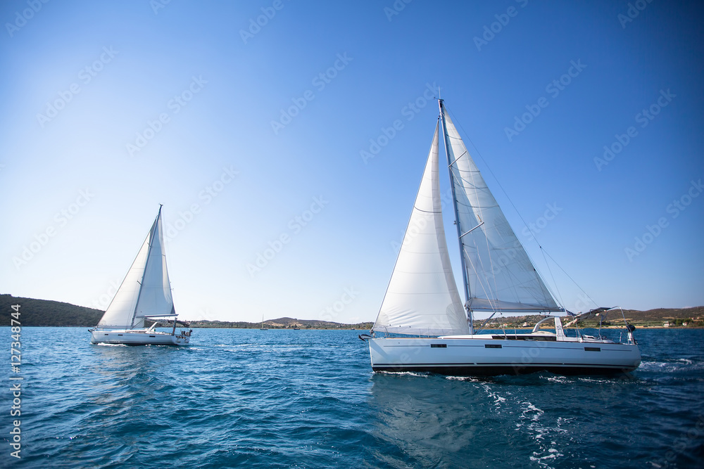 Sailing. Racing yacht in the Aegean Sea on blue sky background. Luxury Lifestyle.