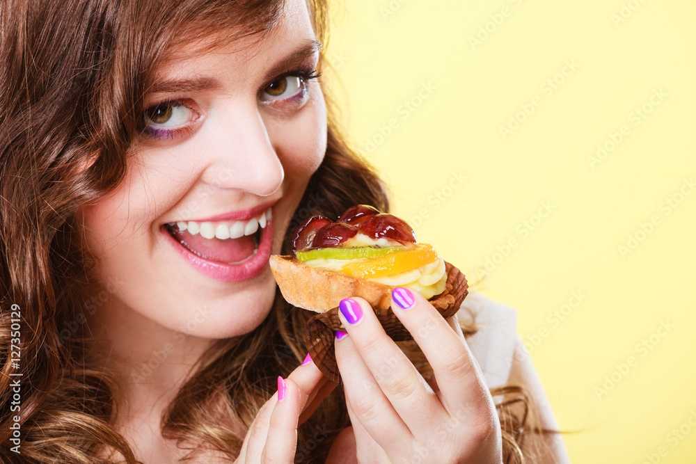 Smiling cute woman holds fruit cake in hand