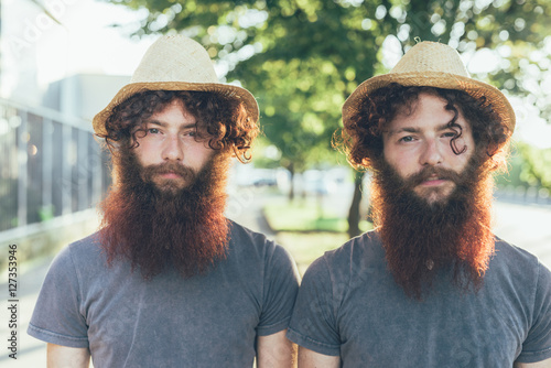 Portrait of twin brothers in straw hats photo