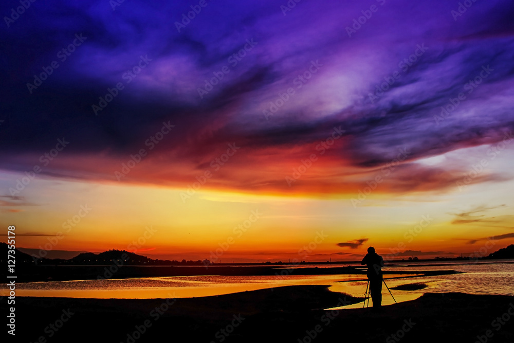 Abstract sunset,Man standing to take a photo sunset,thailand