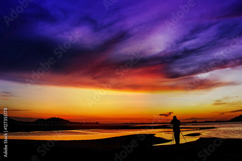 Abstract sunset,Man standing to take a photo sunset,thailand