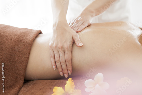 A young lady is receiving a back massage