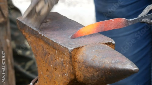 Blacksmith Working on Metal on Anvil photo