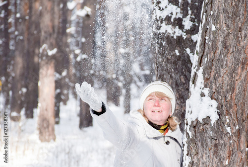 Happy caucasian woman in the snowy park