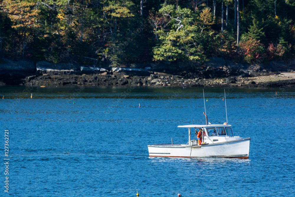 Φωτογραφία Lobster fishing boat in autumn against deep blue ocean water in coastal Maine, N