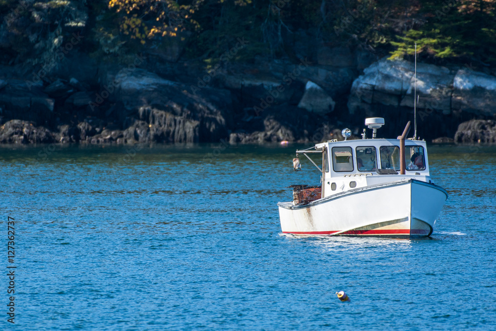 Φωτογραφία Lobster fishing boat in autumn against deep blue ocean water in coastal Maine, N