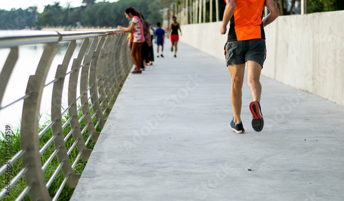 Running man jogging in city park