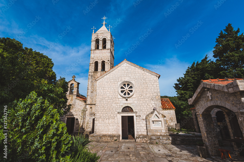 Rezevici abbey is situated between Budva and Petrovac, Montenegro.Stone belfry and facade of The Serbian Orthodox Rezevici Monastery located in Katun Rezevici village near Perazica Do.
