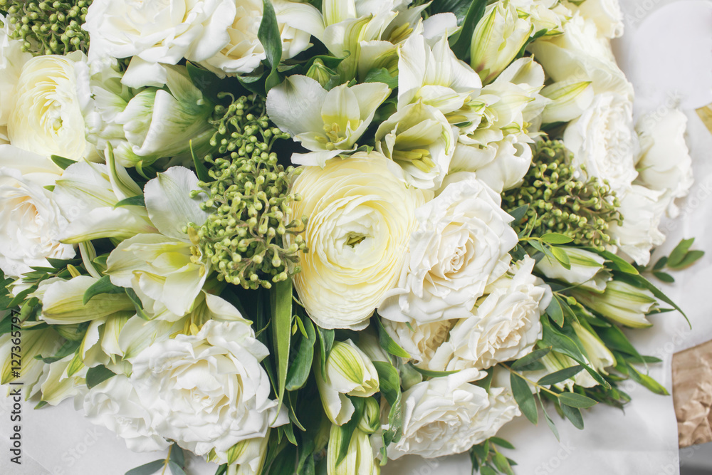 rich bouquet flowers of different colors mixed in woman hand . rich bouquet flowers of different colors mixed in woman hand .